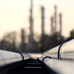 A close-up of a pipeline connecting to a crude oil refinery.